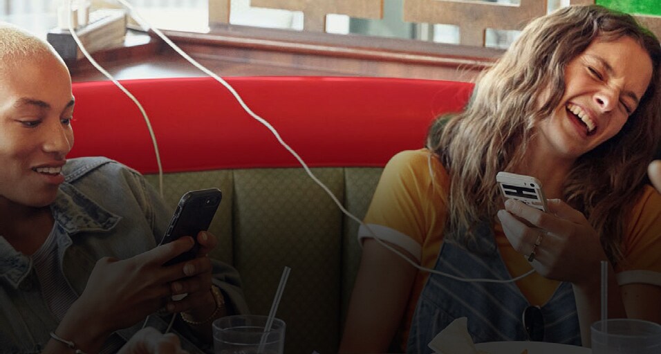 2 women laughing at meal